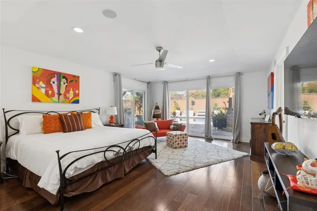 a bedroom with a bed a dresser next to a window