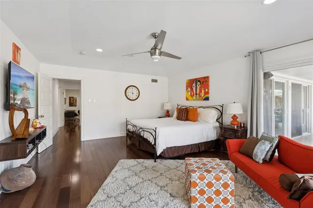 a bedroom with furniture and wooden floor