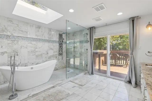 a bathroom with a bathtub and shower
