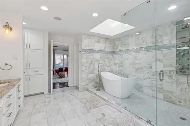 a bathroom with a bathtub and shower