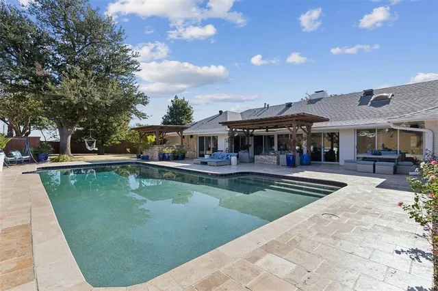 a view of a swimming pool with sitting area