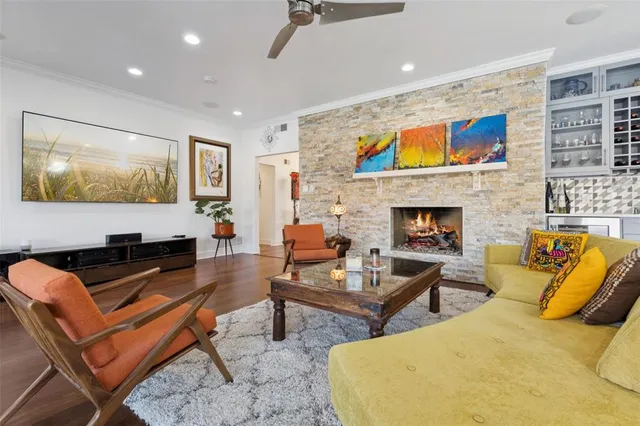 a living room with fireplace furniture and a flat screen tv