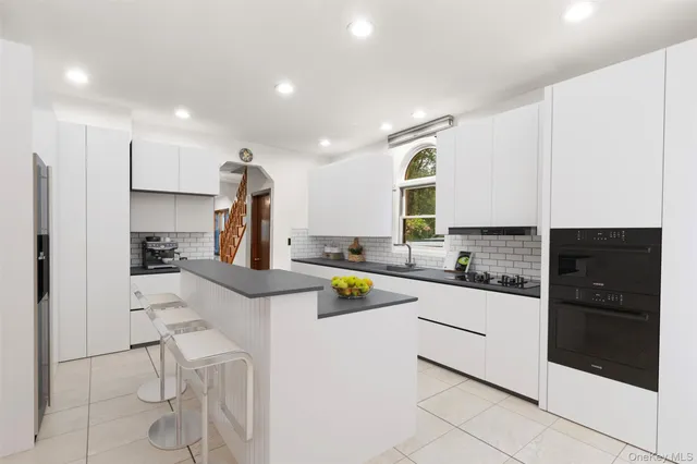 a kitchen with a refrigerator a sink and cabinets