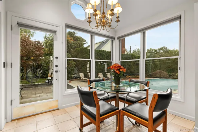 a view of a dining room with furniture wooden floor and a chandelier