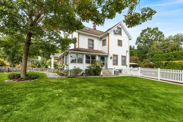 a view of a house with a yard and sitting area