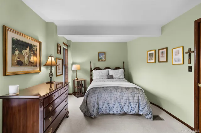 a bedroom with bed chair and window