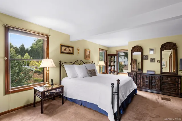 a bedroom with a large bed and a large window