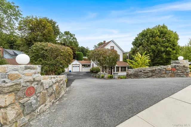 a view of a house with table and chairs in front of it