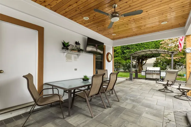 a view of a patio with table and chairs and potted plants