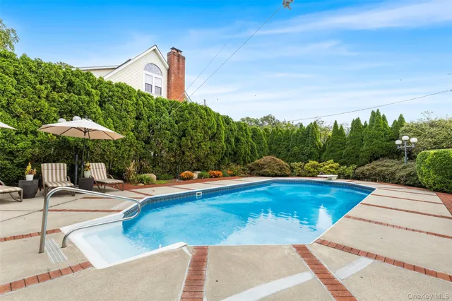 a view of a swimming pool with a lounge chair