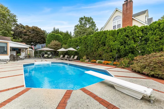 a view of a swimming pool with an outdoor seating and a yard
