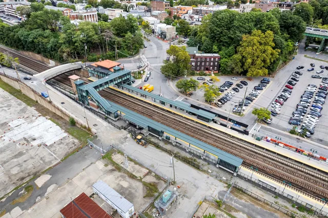 a view of a balcony with chairs and potted plants