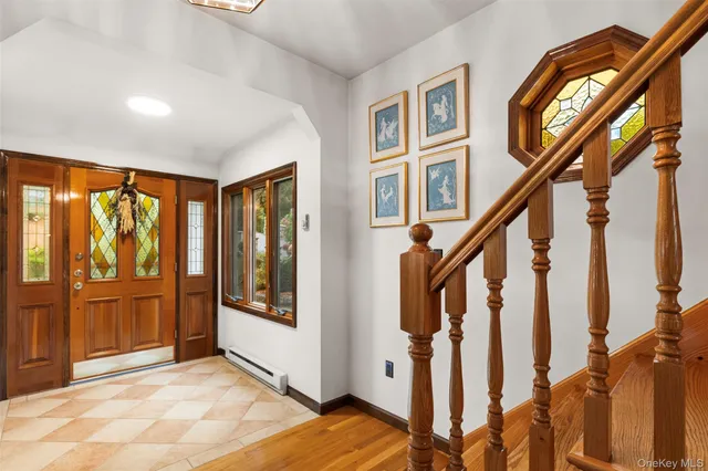 a view of an entryway with wooden floor and door