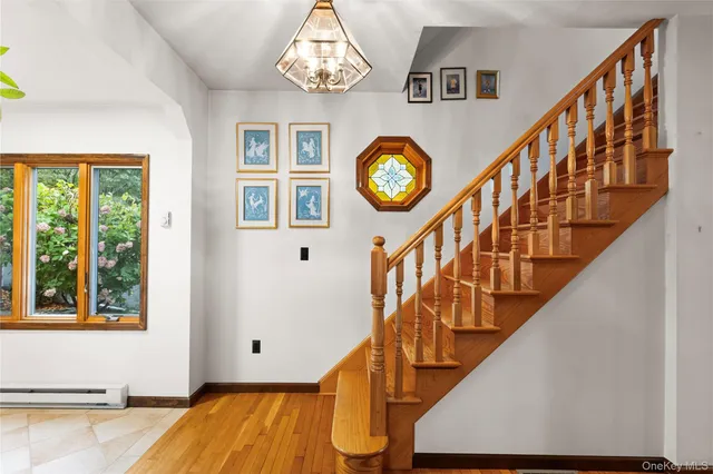 a view of entryway with wooden floor and a clock