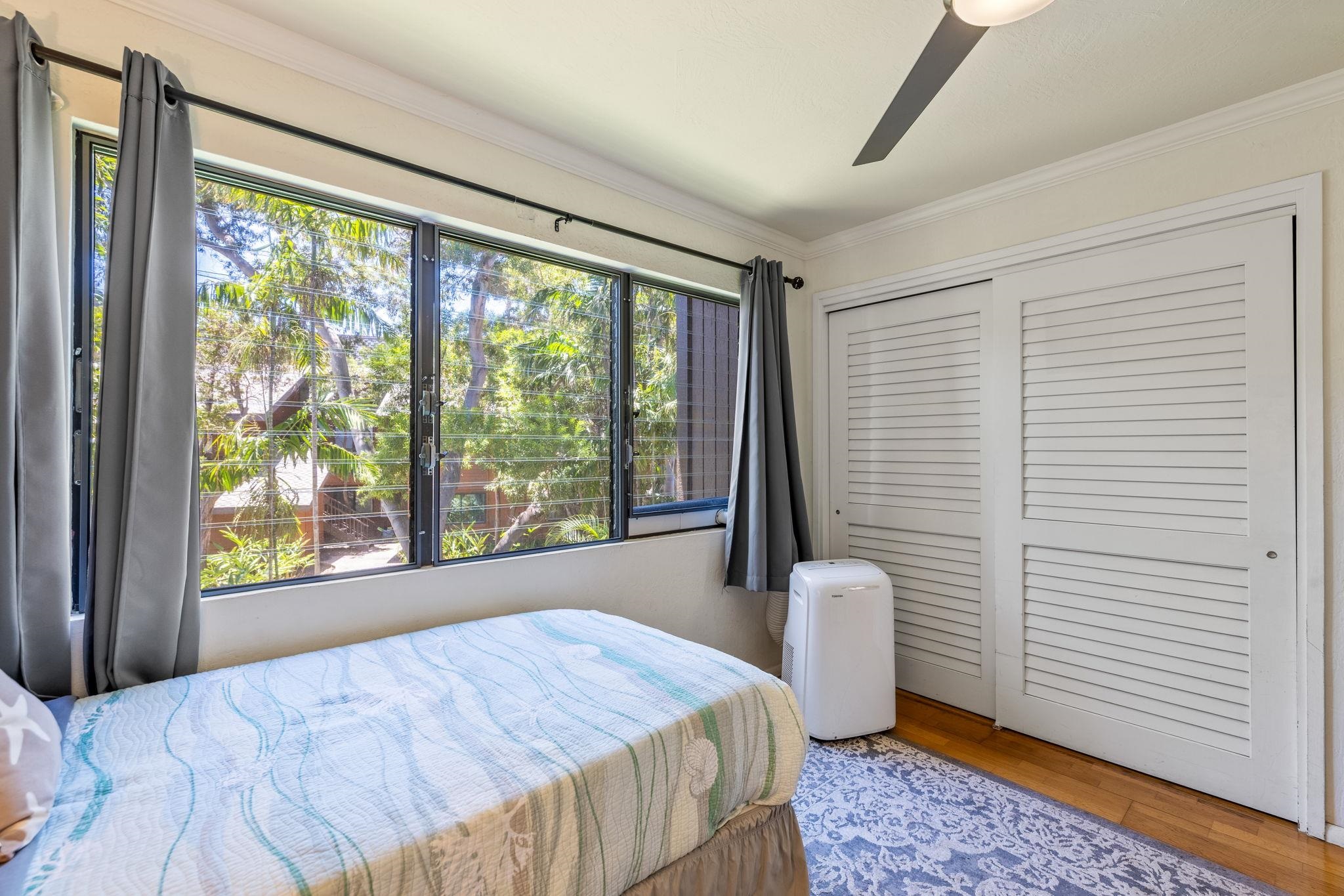 777 South Kihei Road, Unit 221G Kihei, HI 96753 - Photo 19 of 50 a bedroom with a bed and large windows