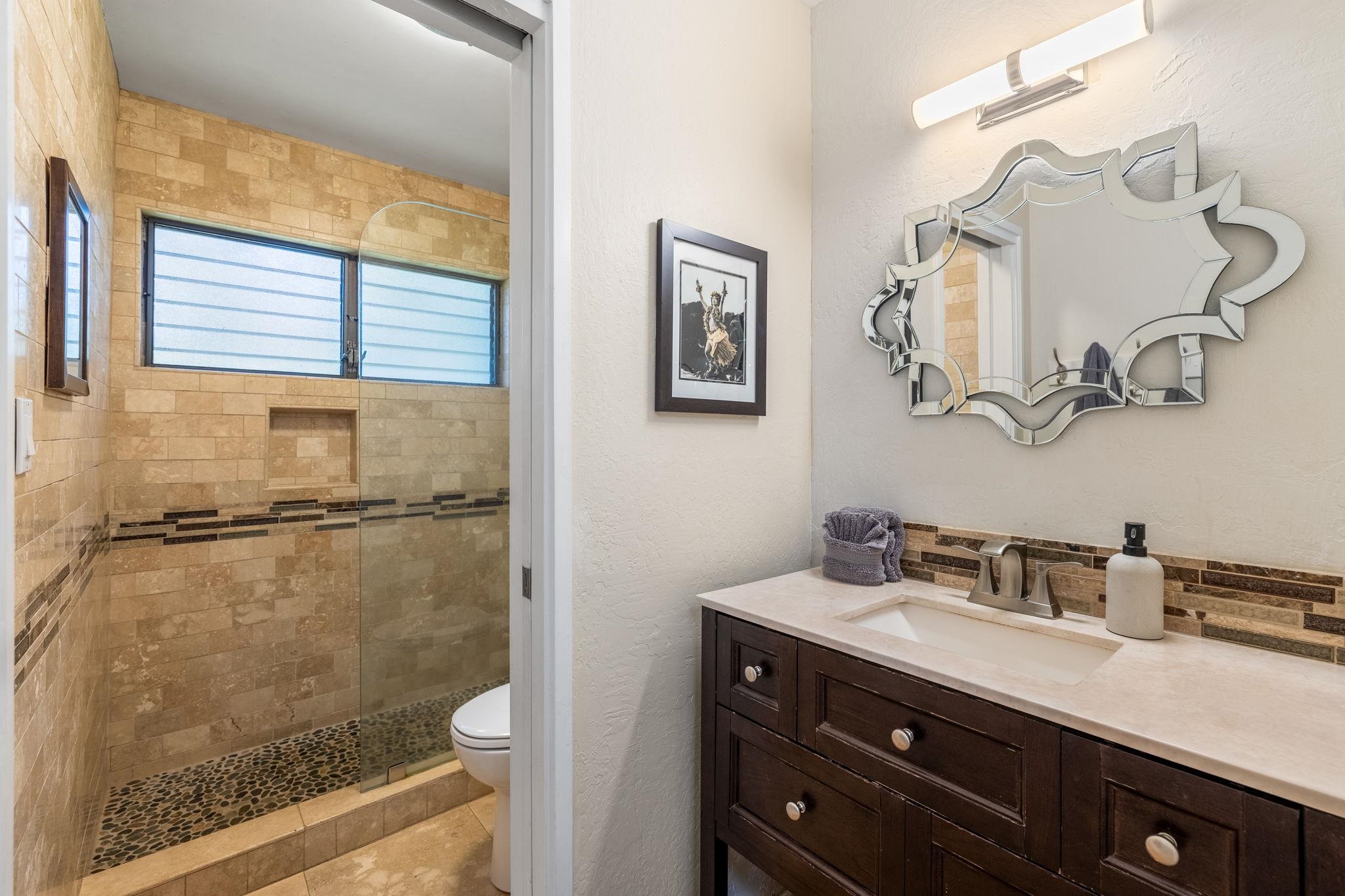 777 South Kihei Road, Unit 221G Kihei, HI 96753 - Photo 21 of 50 a bathroom with a sink a toilet and a mirror