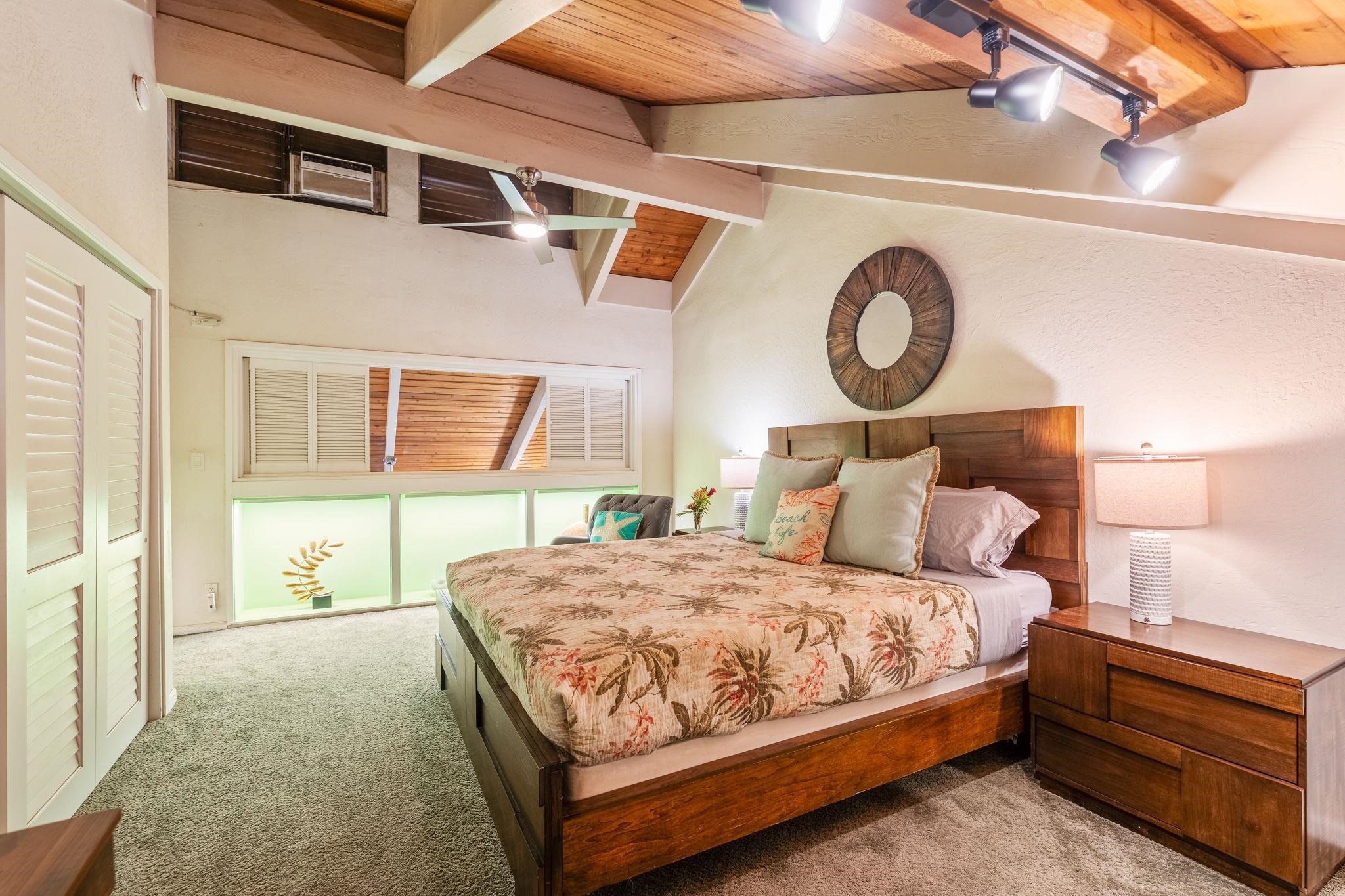 777 South Kihei Road, Unit 221G Kihei, HI 96753 - Photo 29 of 50 a bedroom with a bed and a chandelier