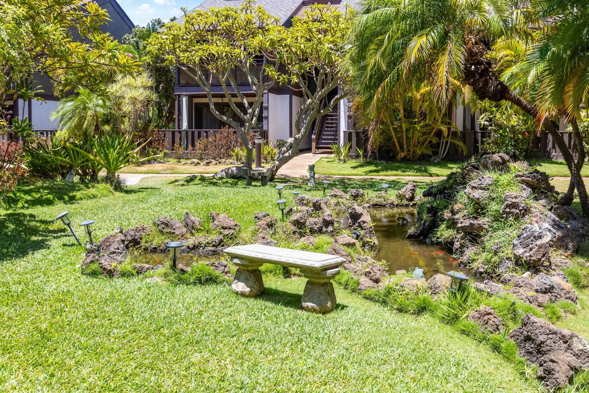 777 South Kihei Road, Unit 221G Kihei, HI 96753 - Photo 39 of 50 a view of a backyard with table and chairs and potted plants and large trees