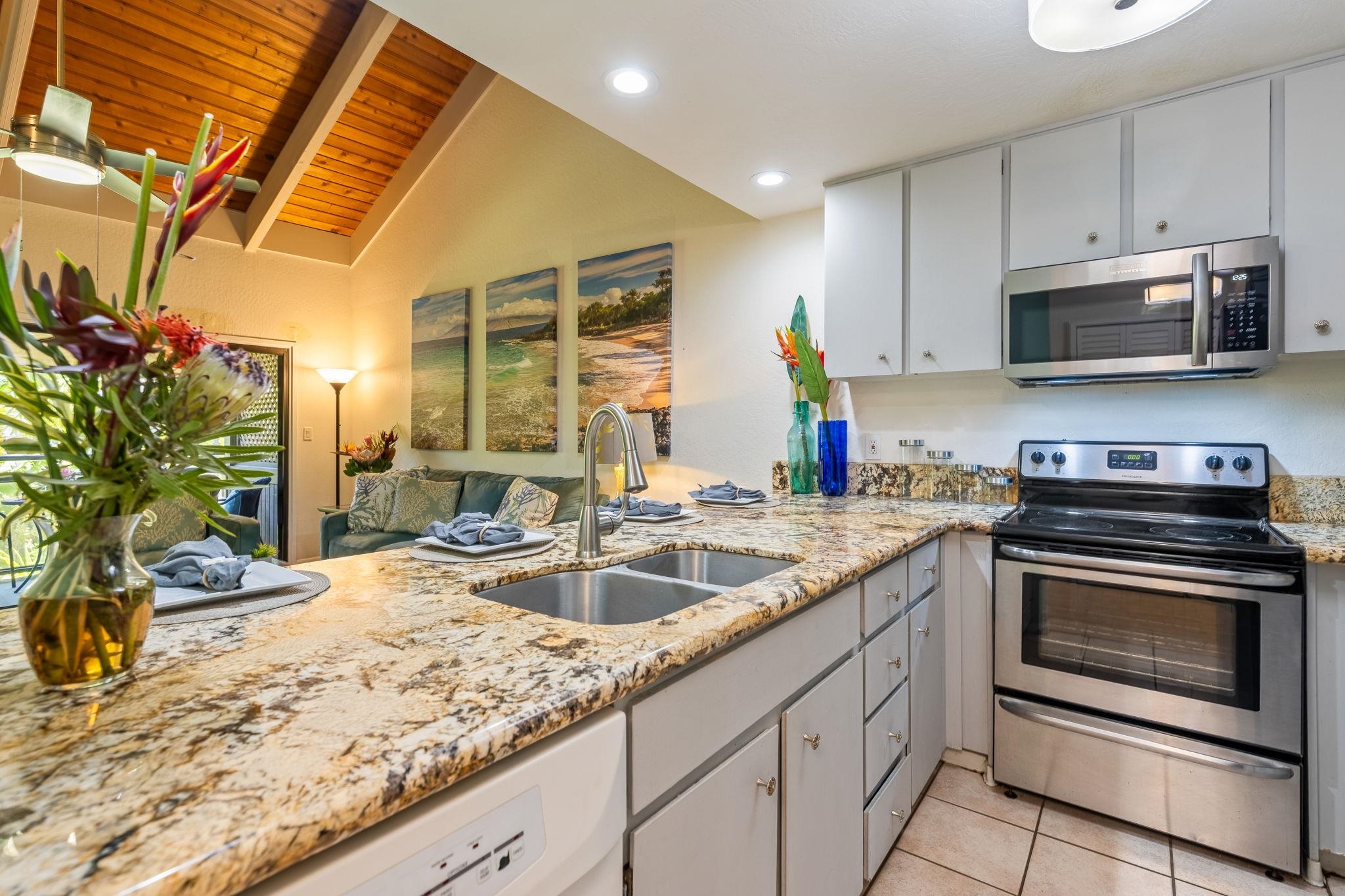 777 South Kihei Road, Unit 221G Kihei, HI 96753 - Photo 9 of 50 a kitchen with stainless steel appliances granite countertop a sink and a stove