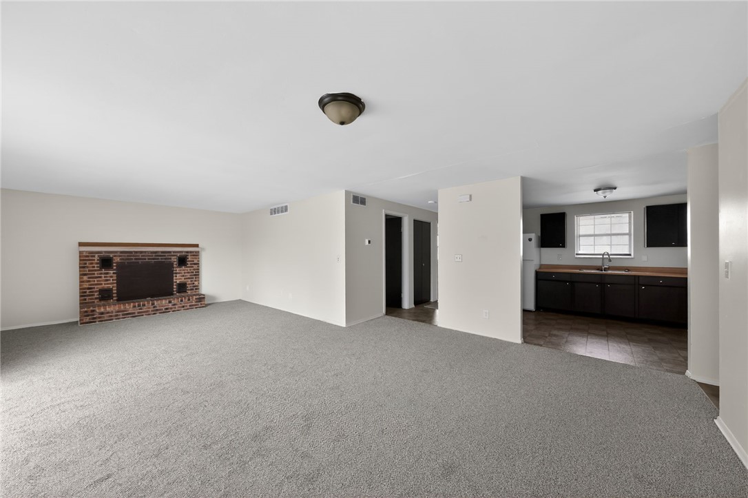 6070 Charlesgate Road Huber Heights, OH 45424 - Photo 15 of 29 This inviting space features a charming fireplace and seamless flow to the adjacent kitchen.