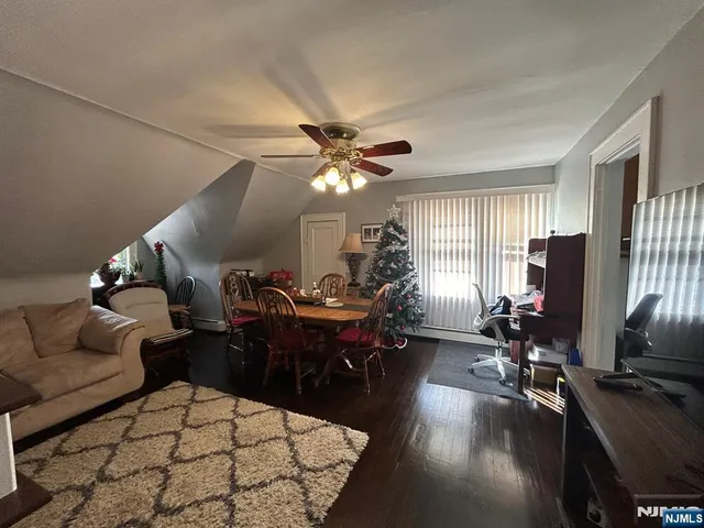 a living room with furniture a chandelier furniture and a large window