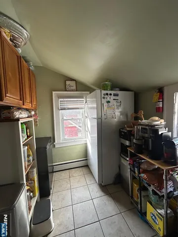 a kitchen with refrigerator and washer