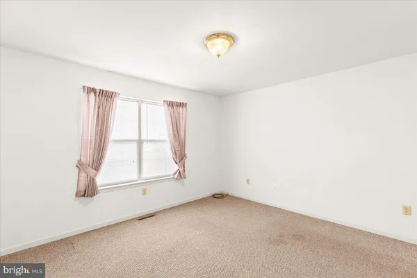 an empty room with a empty space and windows