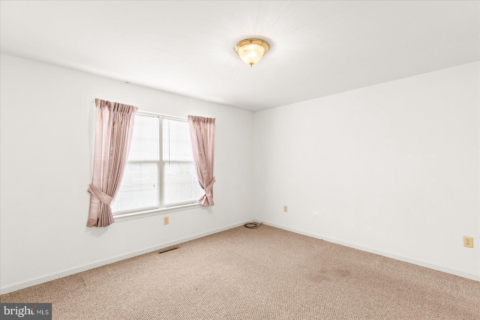 99 Furlong Way, Unit 99 Red Lion, PA 17356 - Photo 13 of 49 an empty room with a empty space and windows