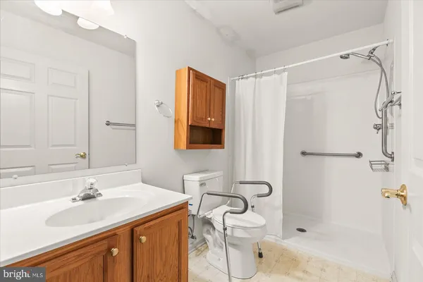 a bathroom with a sink toilet double vanity and shower