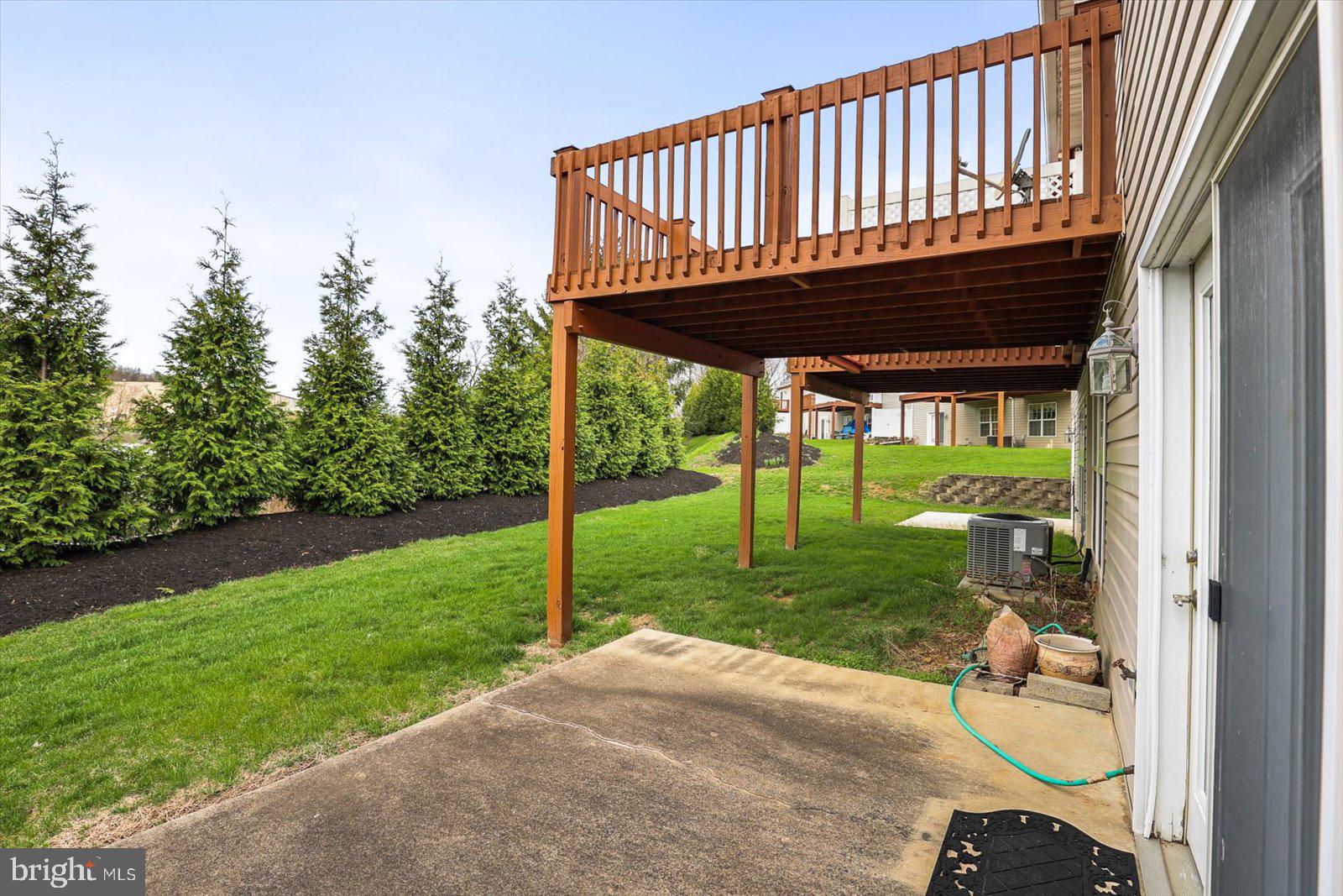 99 Furlong Way, Unit 99 Red Lion, PA 17356 - Photo 32 of 49 a view of a deck with a big yard potted plants and large tree
