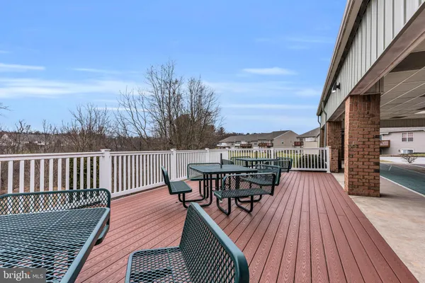 a living room with lots of furniture and clutter