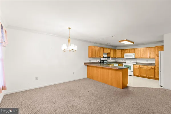 a kitchen with granite countertop a sink cabinets and wooden floor
