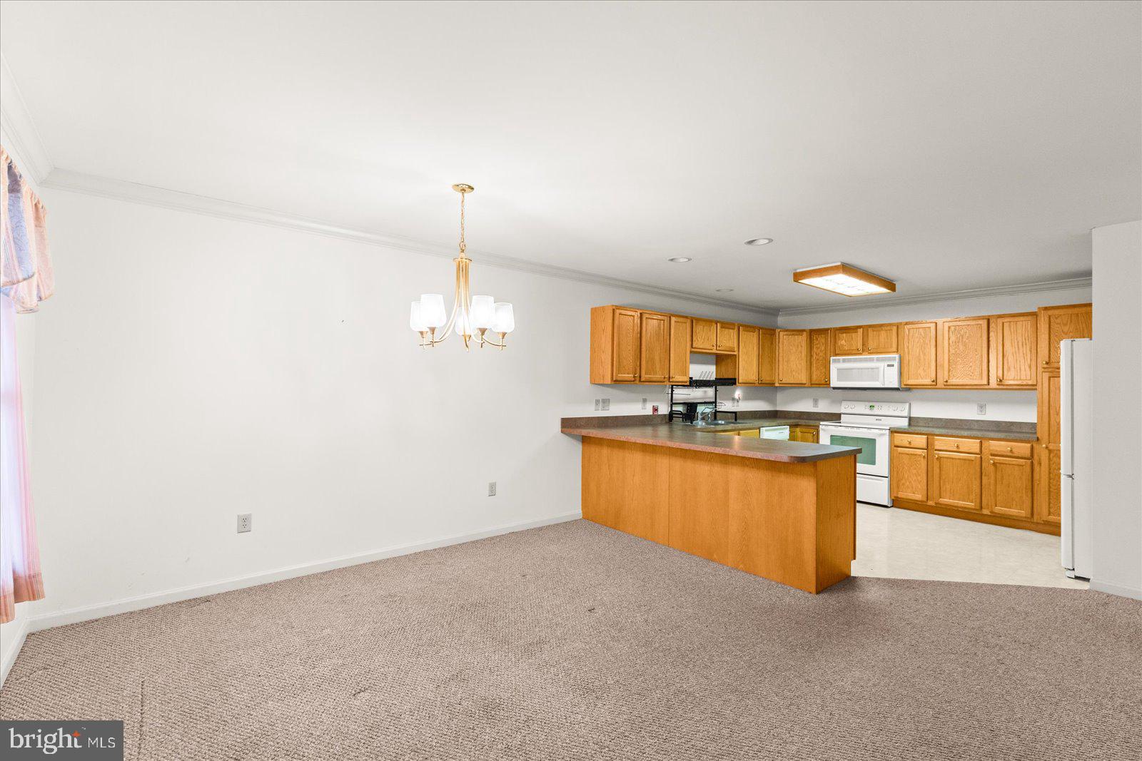 99 Furlong Way, Unit 99 Red Lion, PA 17356 - Photo 4 of 49 a kitchen with granite countertop a sink cabinets and wooden floor