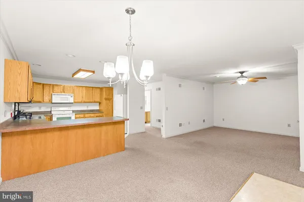 a view of a kitchen with a sink and a chandelier