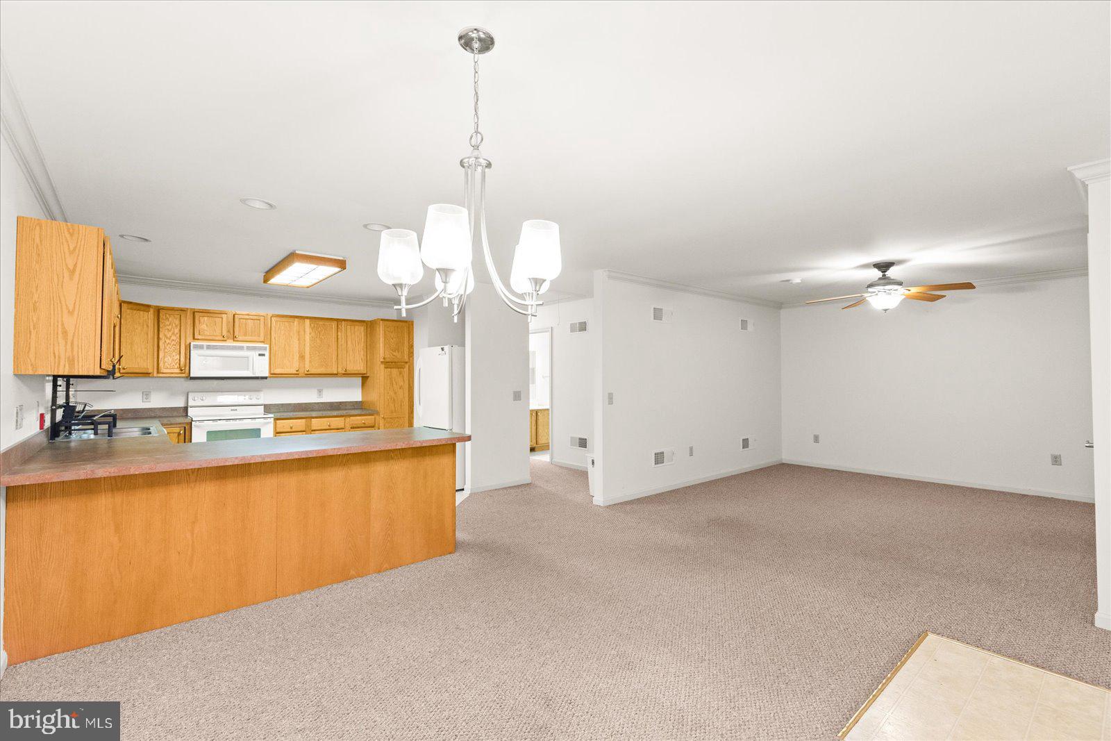99 Furlong Way, Unit 99 Red Lion, PA 17356 - Photo 5 of 49 a view of a kitchen with a sink and a chandelier
