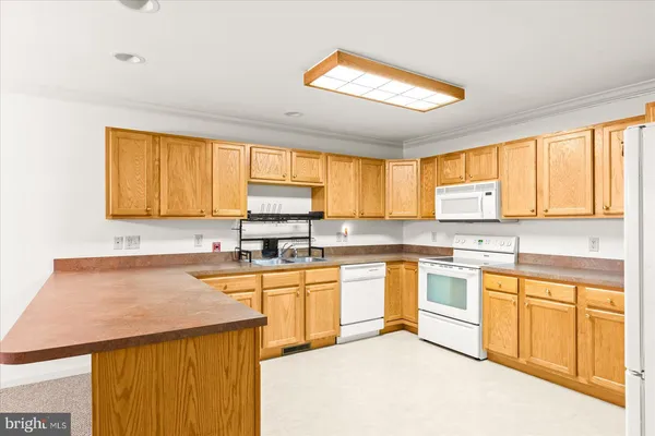 a kitchen with stainless steel appliances granite countertop a sink and cabinets