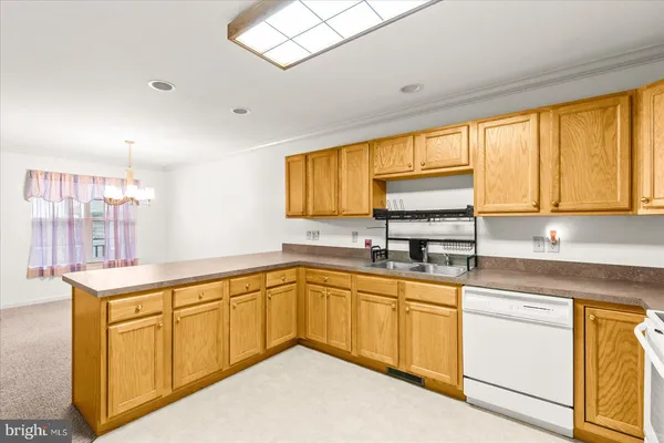 a kitchen with a sink cabinets and window