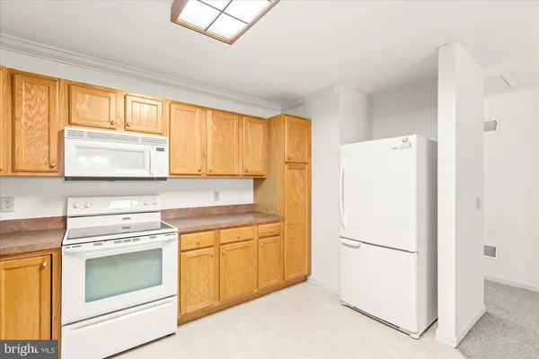 a kitchen with a stove a refrigerator and a sink