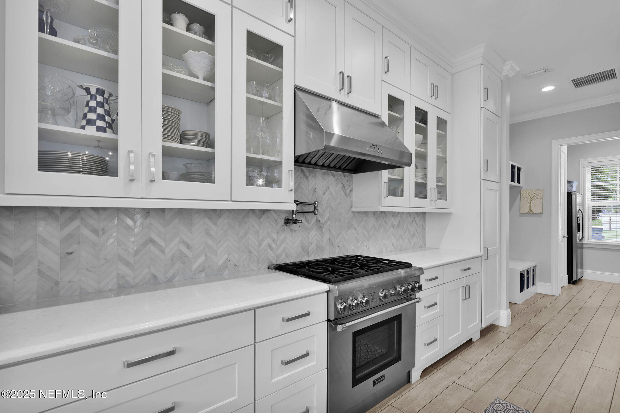 2624 Wrightson Drive Jacksonville, FL 32223 - Photo 11 of 52 a kitchen with stainless steel appliances a stove and cabinets