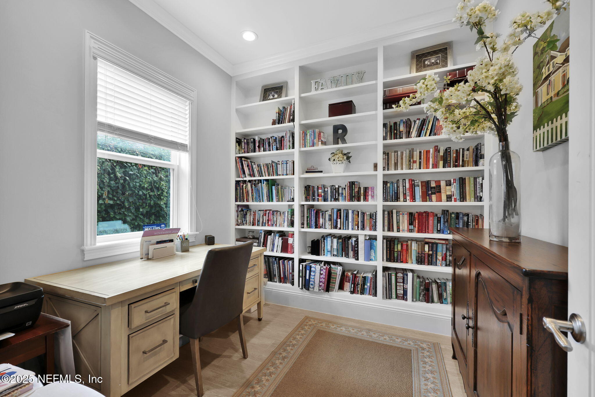 2624 Wrightson Drive Jacksonville, FL 32223 - Photo 12 of 52 a view of a workspace with furniture and a bookshelf