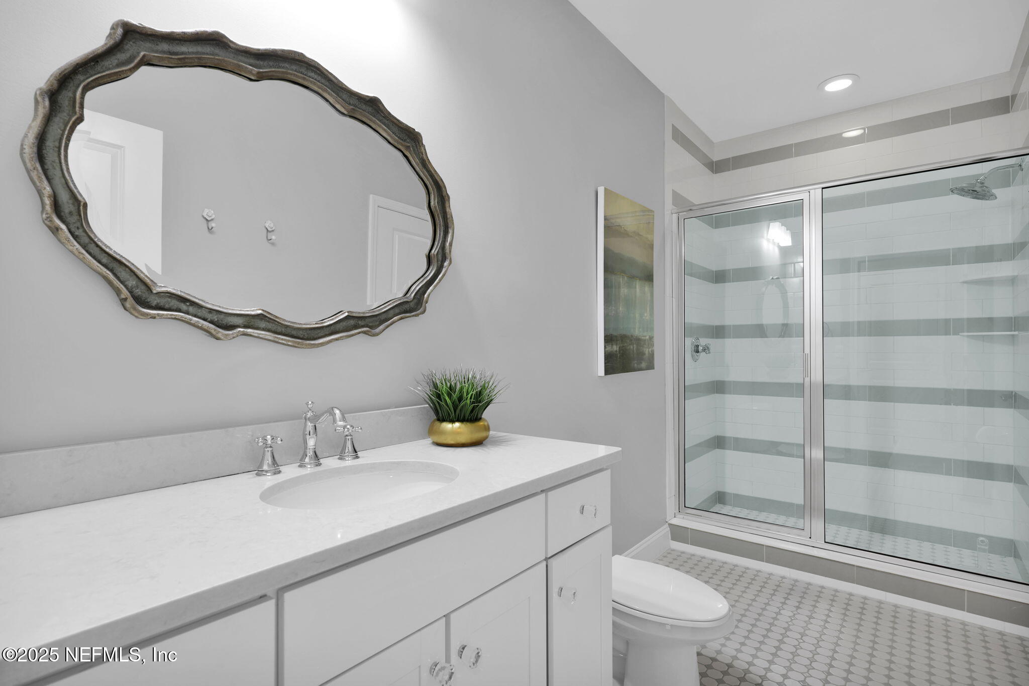 2624 Wrightson Drive Jacksonville, FL 32223 - Photo 50 of 52 a bathroom with a sink a toilet and a mirror