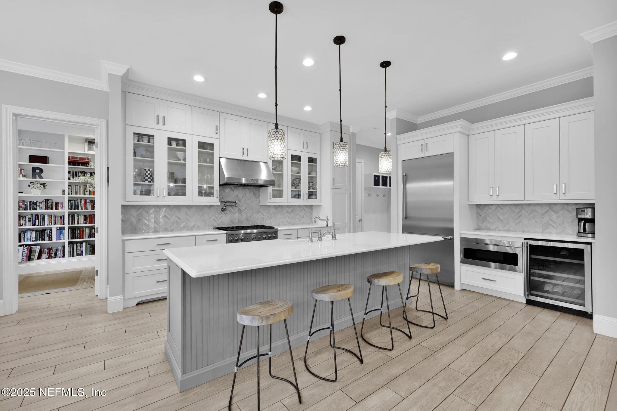 2624 Wrightson Drive Jacksonville, FL 32223 - Photo 9 of 52 a kitchen with stainless steel appliances kitchen island a table chairs sink and cabinets