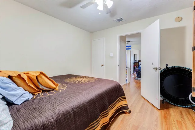 a bedroom with a bed and dresser