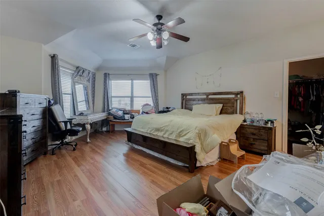 a bedroom with a bed and wooden floor