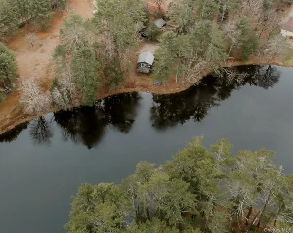 a view of a house with a wooden deck and a trees