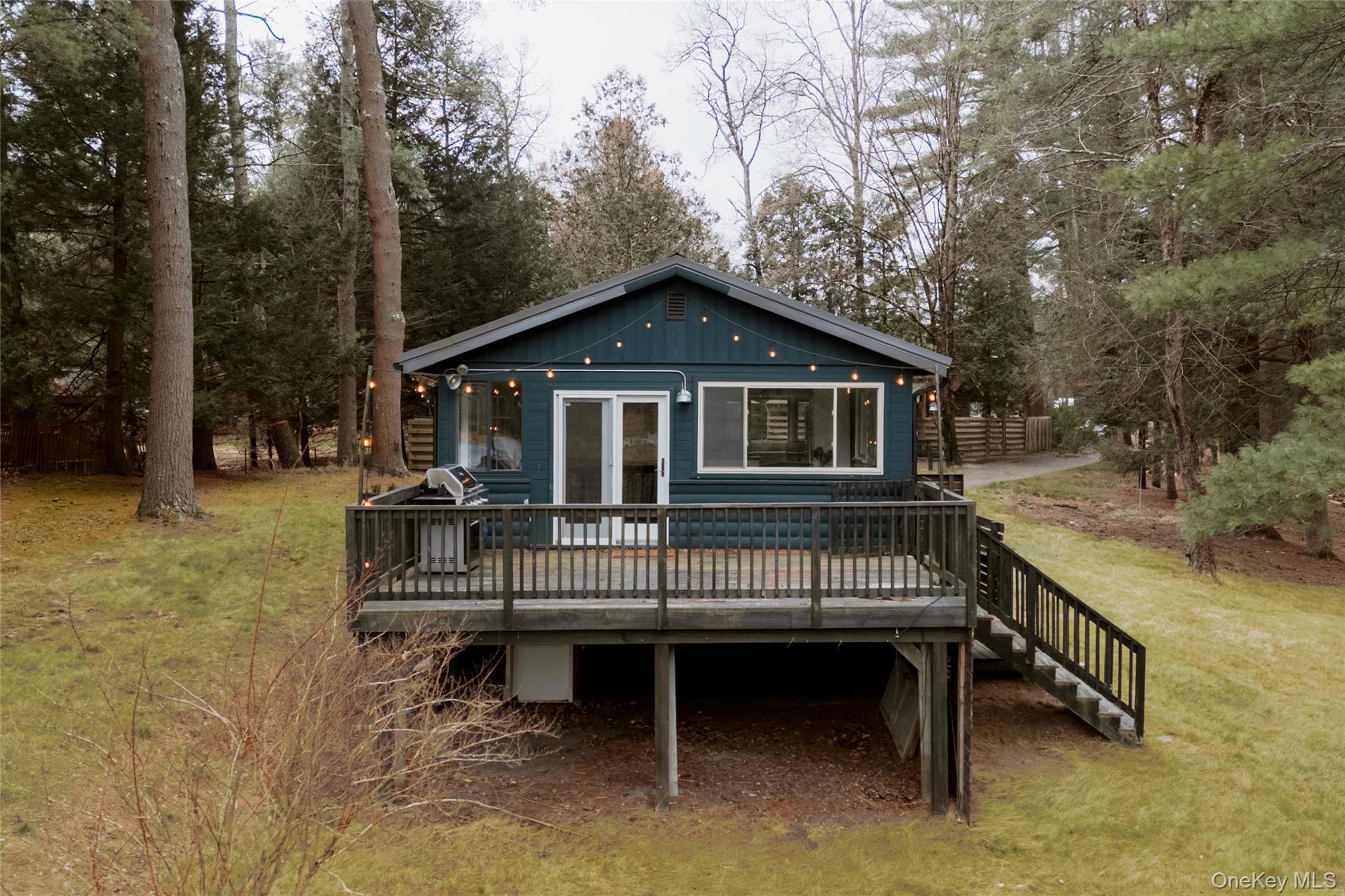 40 Beaver Brook Road Yulan, NY 12792 - Photo 12 of 25 a view of a house with a wooden deck and a trees