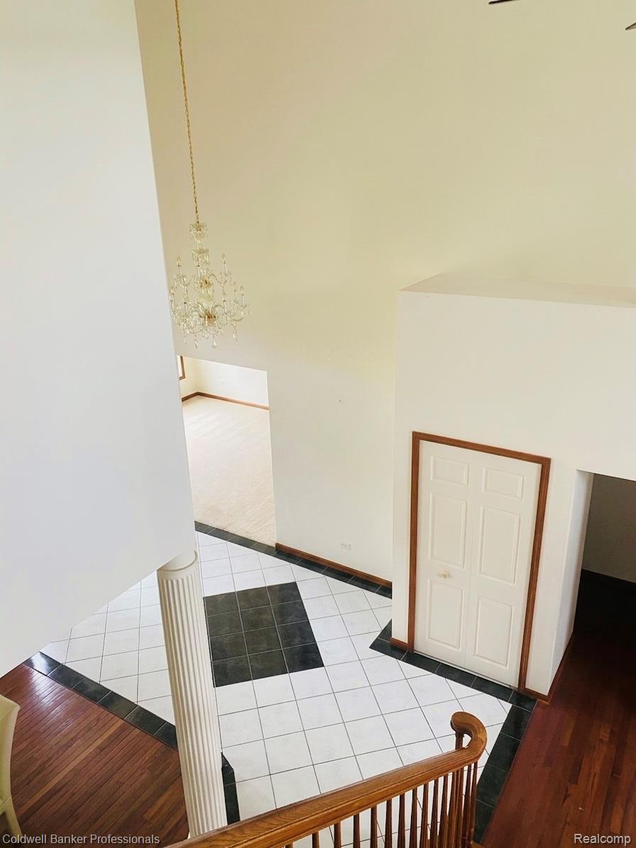 11171 Lapeer Road Davison, MI 48423 - Photo 37 of 42 Corridor with light tile patterned floors and hanging lights