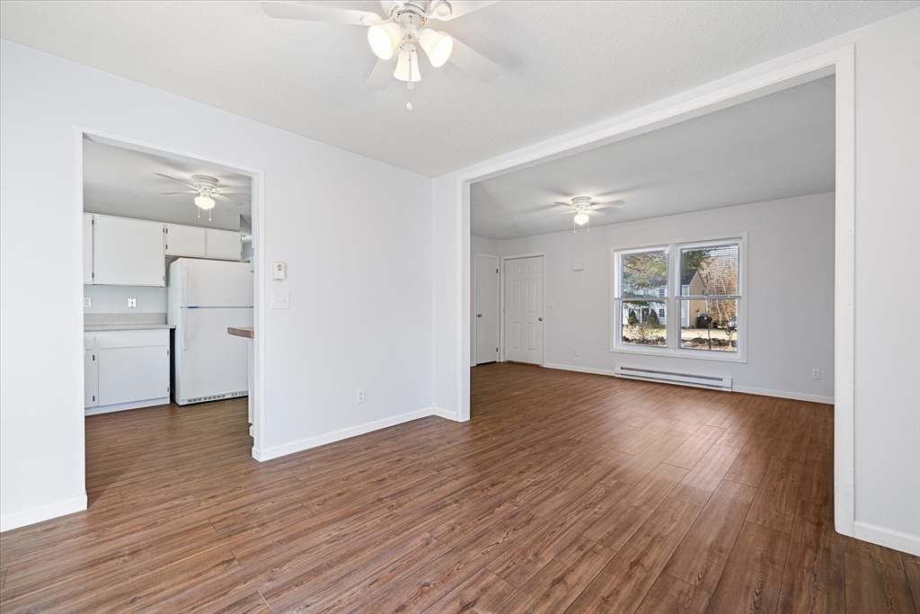 359 Bemis Road Warren, MA 01585 - Photo 11 of 27 a view of an empty room with wooden floor and a window
