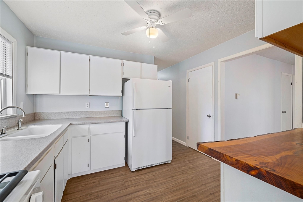 359 Bemis Road Warren, MA 01585 - Photo 15 of 27 a view of a kitchen with wooden floor