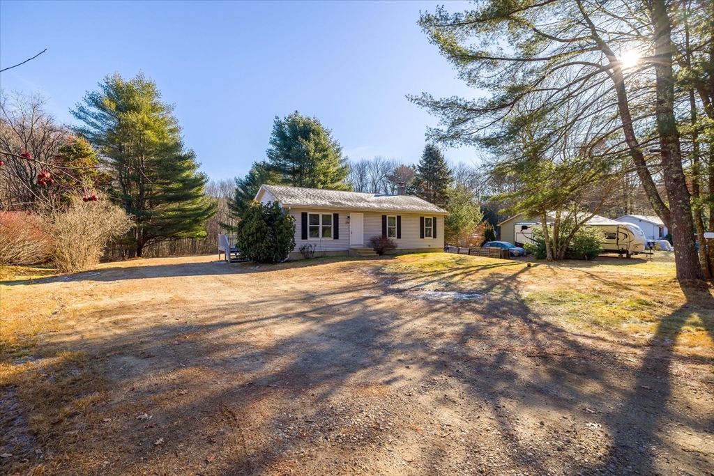 359 Bemis Road Warren, MA 01585 - Photo 2 of 27 a view of house with yard and trees in the background